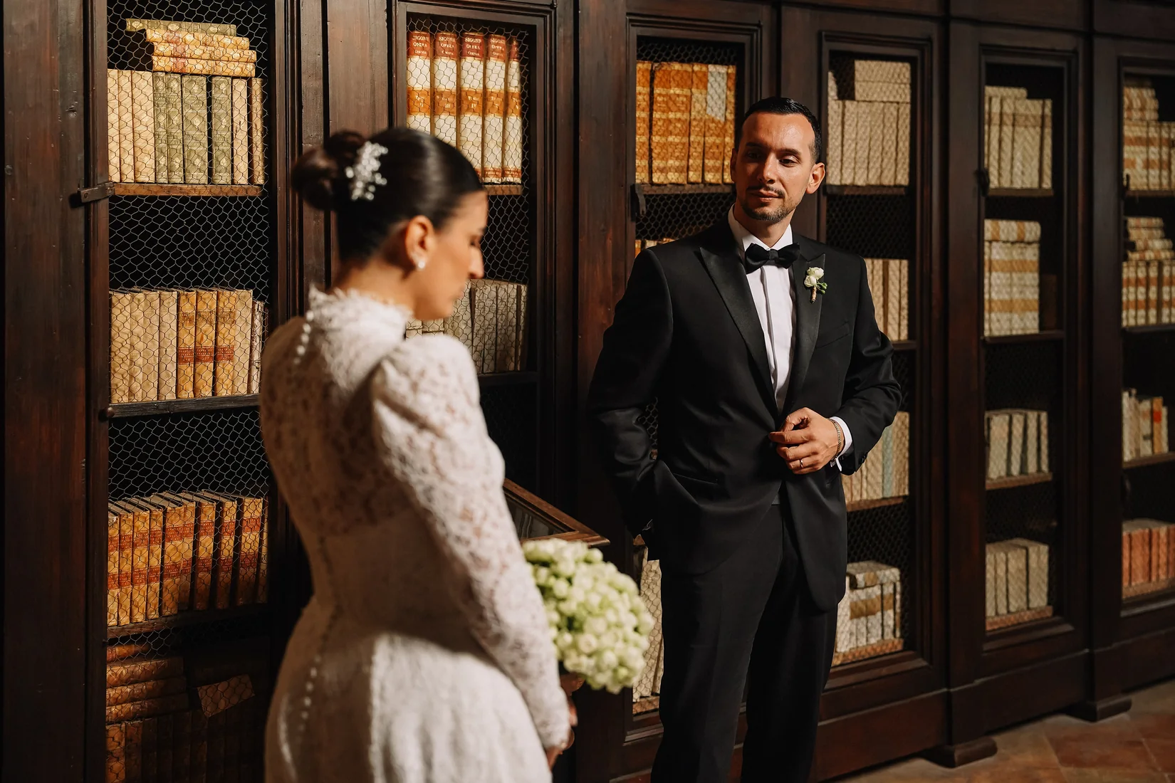 Bride and groom photographed in a warmly lit historic interior by Mauro Silvestre